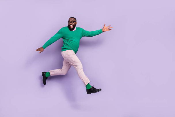 Full body image of good mood energetic young man running forward go on walk isolated on purple color background. - Foto, Imagem