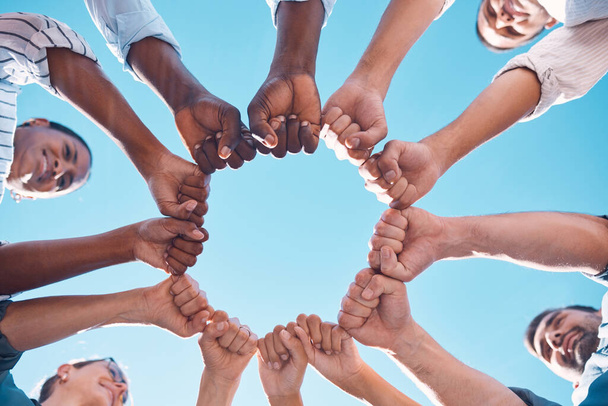 Fist bump, teamwork and business people in a team building meeting for collaboration, motivation and support. Global, below view and workers hands in a huddle startup for goals, targets and mission. - Foto, Imagem