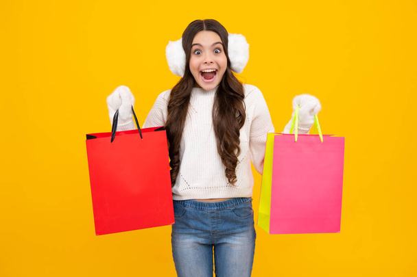 Autumn shopping sale. Excited teenager girl. Stylish teen girl with shopping sale bags. Kid holding purchases - Photo, Image