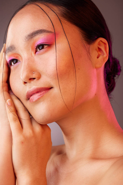 Japan face, neon makeup or model woman for skincare, facial beauty or cosmetics wellness in studio. Skin health, relax and peace girl with pink eyeshadow, luxury product or creative organic art. - Fotografie, Obrázek