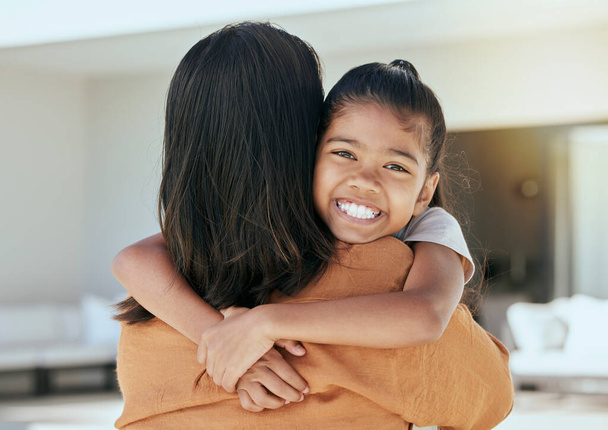 Mom, girl and bonding hug in house living room or family home in mothers day celebration, birthday or security. Portrait, smile or happy child with woman or Indonesian parent in trust, safety or love. - Foto, imagen