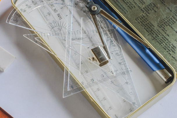 Compasses, pencil and rulers on squared paper - Photo, Image