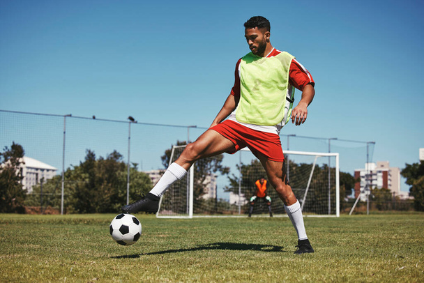 Soccer, sports and game energy of a man athlete from Israel in a fitness workout and training kick. Exercise, football and healthy cardio of a person with match focus on field grass in summer. - Photo, Image