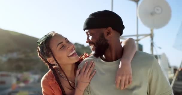 Interracial couple, hug and bonding on city building rooftop for summer holiday, travel vacation date and location break in Boston. Smile, happy black man and talking woman or student fashion friends. - Footage, Video