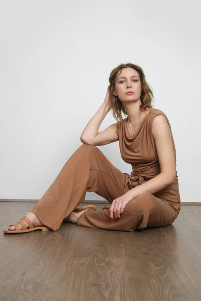 Studio shot of woman in beige cotton casual outfit,  sleeves shirt and basic pants. - Fotografie, Obrázek
