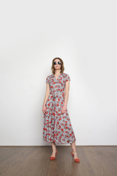 Studio shot of woman in floral summer dress. - Фото, зображення