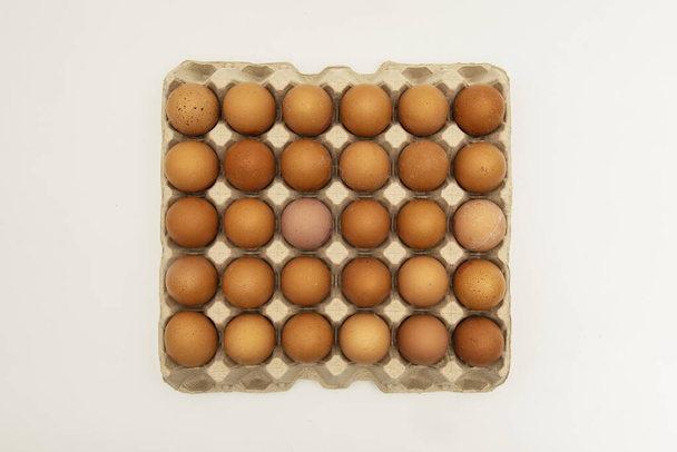Cardboard box with fifty chicken eggs - Foto, imagen