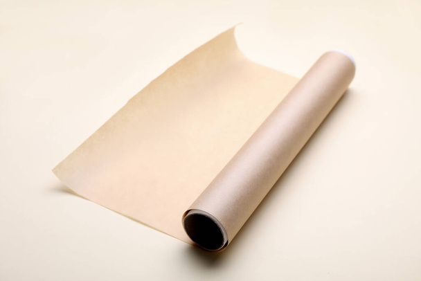 Roll of baking paper on beige background - Fotó, kép