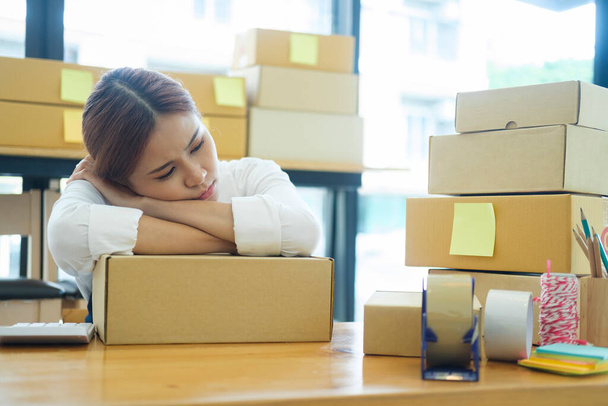 Asian female online business owner feeling disappointed and frustrated after checking online sales with low order. Female entrepreneur getting tired for being unsuccesful at her online business. - Photo, image