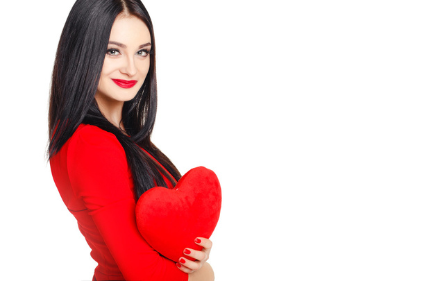 Portrait of Beautiful woman with bright makeup and red heart in hand - Photo, Image