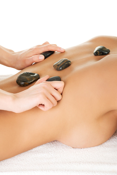 Young attractive woman getting hot stone massage - Foto, Imagen