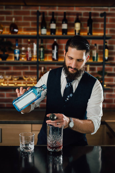 barman preparing cocktails on bar counter - Photo, Image