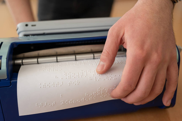 Blind man using braille typewriter - Foto, imagen