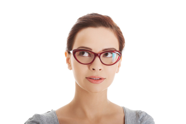 Portrait of a woman in eyewear looking up - Photo, Image