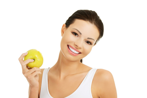 Smiling beauty holding green apple - Foto, afbeelding