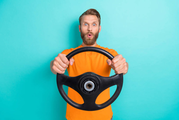 Photo of impressed young man pouted lips arms hold steering wheel isolated on emerald color background. - Foto, Imagem
