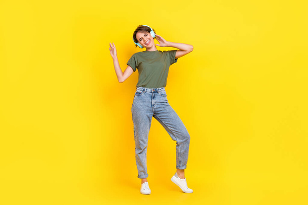 Full length photo of pretty positive lady music lover dressed stylish clothes free time playlist isolated on yellow color background. - Zdjęcie, obraz