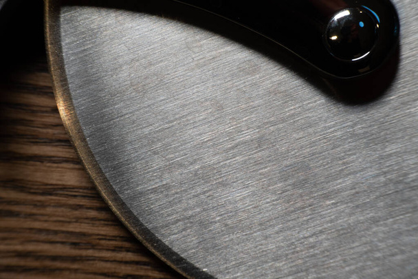 Large metal pizza cutter close up - Φωτογραφία, εικόνα