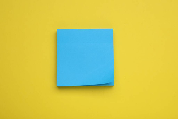Paper note on yellow background, top view - Zdjęcie, obraz