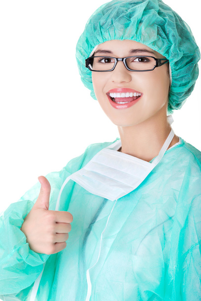 Female doctor in protective mask gesture thumb up - Photo, image