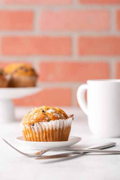 Blueberry muffins with white table place setting. - 写真・画像