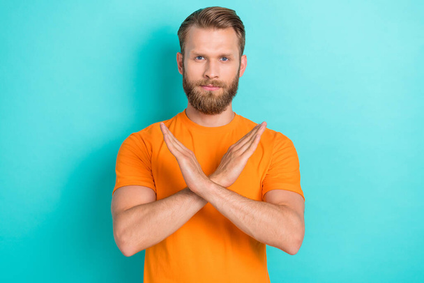 Photo of strict beard guy cross arms wear orange t-shirt isolated on turquoise color backgroiund. - Foto, imagen