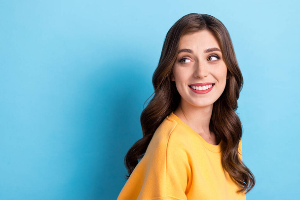 Photo portrait of attractive young girl enjoy fresh hairdo look empty space dressed stylish yellow outfit isolated on blue color background. - Foto, Imagen