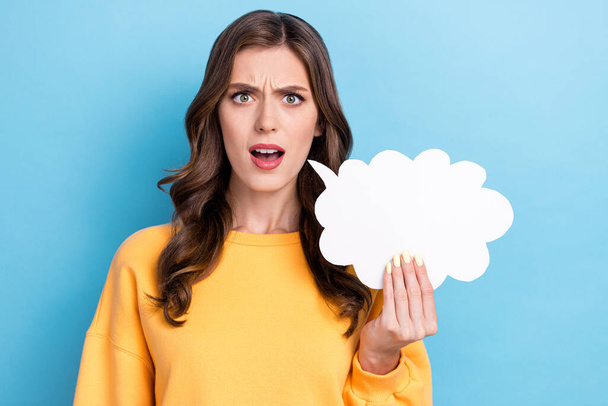 Closeup photo of young adorable pretty nice gorgeous girl unhappy surprised hold paper white cloud excited face isolated on blue color background. - Фото, зображення