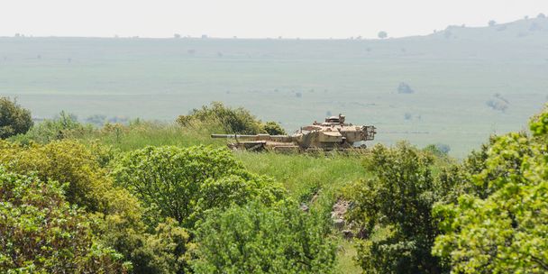 Israeli tank on combat duty in the field on Golan Heights - Photo, Image