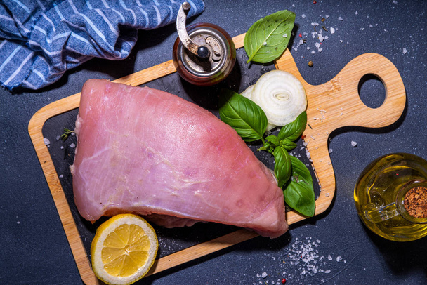 Raw turkey breast filet with spices for cooking. Turkey breast white meat cooking background copy space top view - Valokuva, kuva