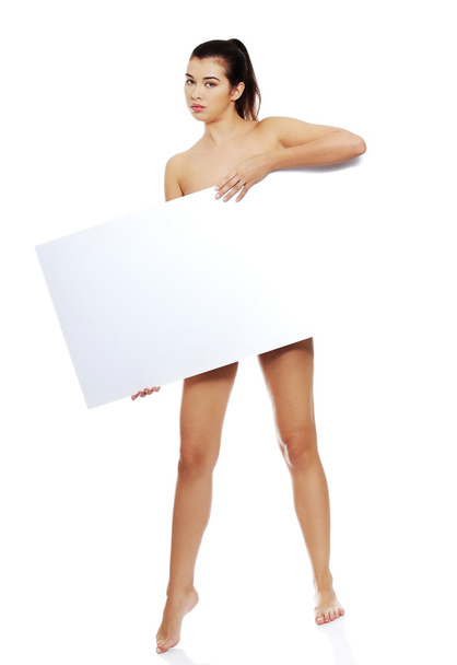 Full length nude woman holding blank banner - 写真・画像