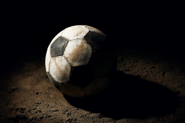 Soccer ball on ground on dark background - Foto, imagen