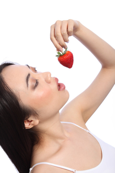 Sexy oriental girl eating red strawberry fruit - Foto, imagen
