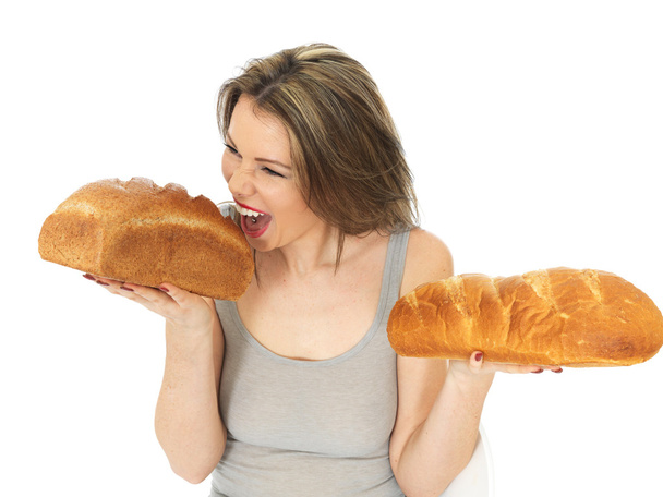 Young Woman Comparing White and Brown Bread - Фото, зображення
