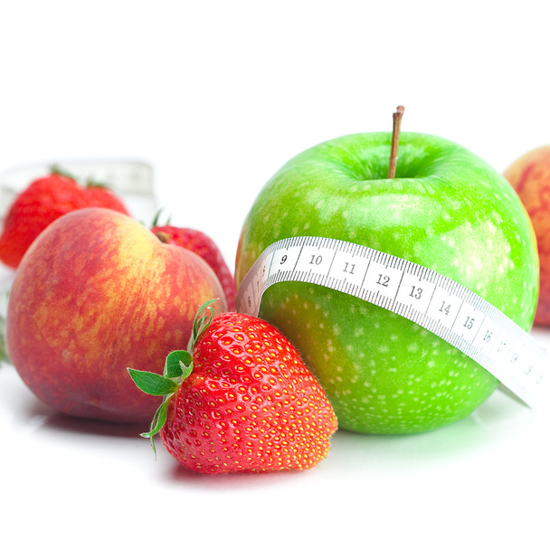 Big juicy red ripe strawberries,apple,peas,peach and measure tap - Фото, изображение