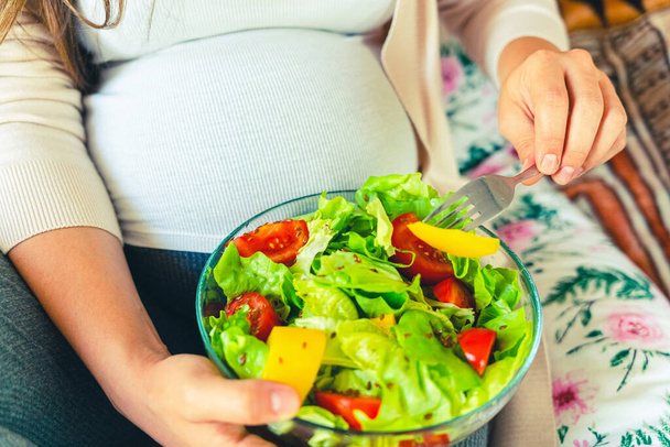 Pregnant healthy food diet. Pregnancy woman eating nutrition diet food salad. Healthy vegetarian food, healthy lifestyle - Photo, image