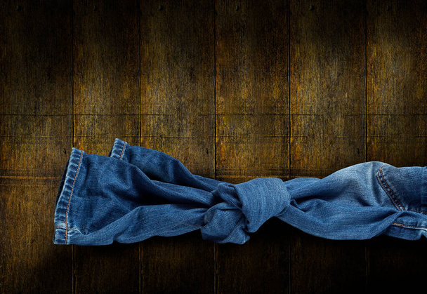 "Jeans knot on wooden background" - Foto, immagini