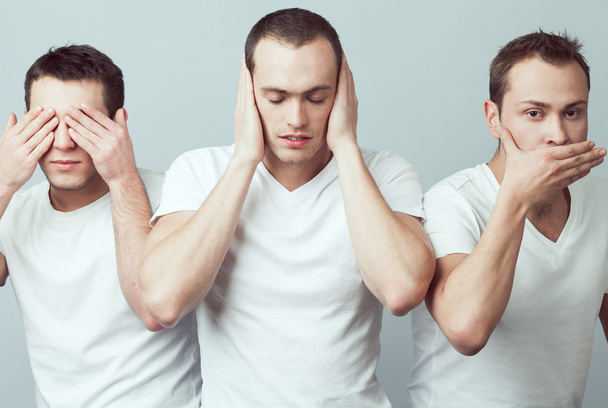 Closeup portrait of three young men in white t-shirts imitating  - Foto, afbeelding