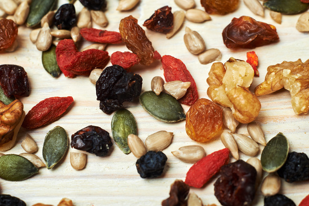 mix nuts seeds and dry fruits, on a wooden table - Фото, изображение