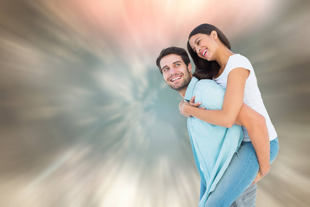 "Composite image of happy casual man giving pretty girlfriend piggy back" - Photo, Image