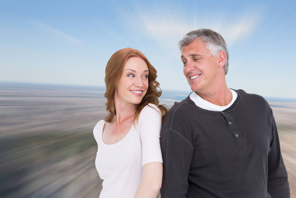 "Composite image of casual couple smiling at each other" - Photo, Image