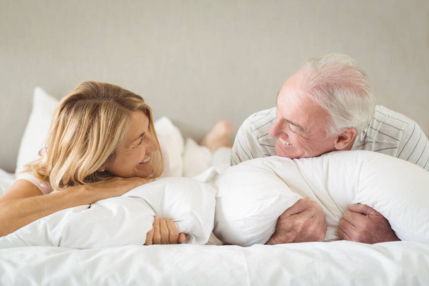 "Happy senior couple lying on bed " - Photo, image