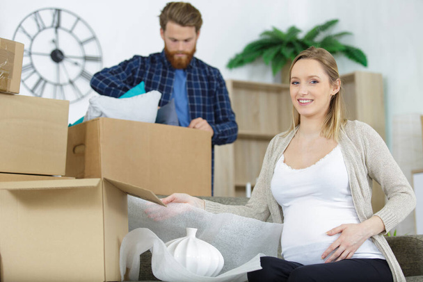 young couple moving to new flat with fragile things - Foto, Imagem