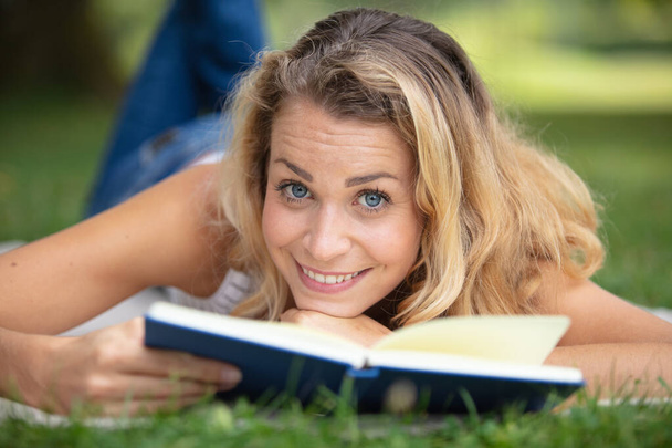 woman relaxing outdoors looking happy and smiling - Photo, Image