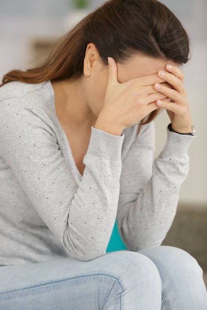 woman crying on the sofa after relationship breakup - Valokuva, kuva