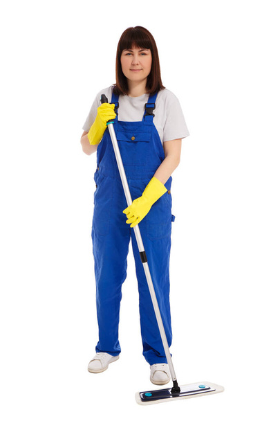 professional cleaning service concept - full length portrait of young woman cleaner in blue uniform cleaning floor with mop isolated on white background - Foto, Bild