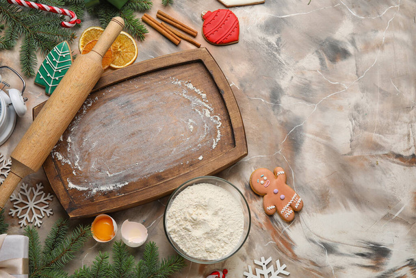 Komposition mit Holzbrett, Nudelholz und Zutaten für die Zubereitung von Weihnachtsplätzchen auf Grunge-Hintergrund - Foto, Bild