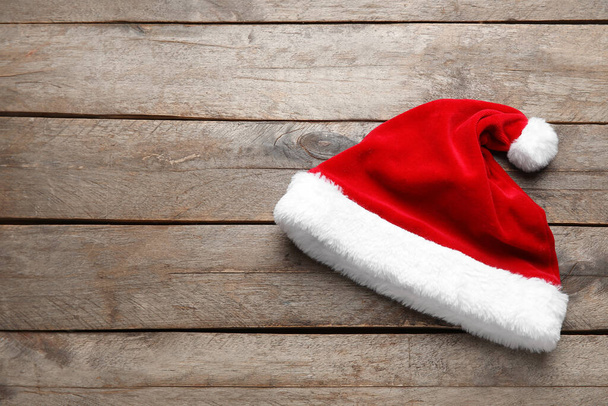 Santa hat on wooden background - Photo, Image
