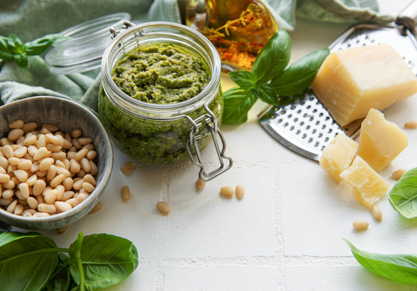 Fresh made Pesto sauce. Green basil pesto.  Ingredient for pesto sauce - Fresh Basil, Pine Nuts, Olive Oil and Cheese - Foto, immagini