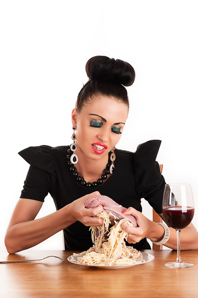 Greedy woman eating raw meat - 写真・画像